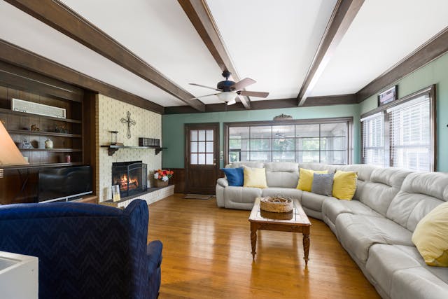 living room with white couch and yellow pillows